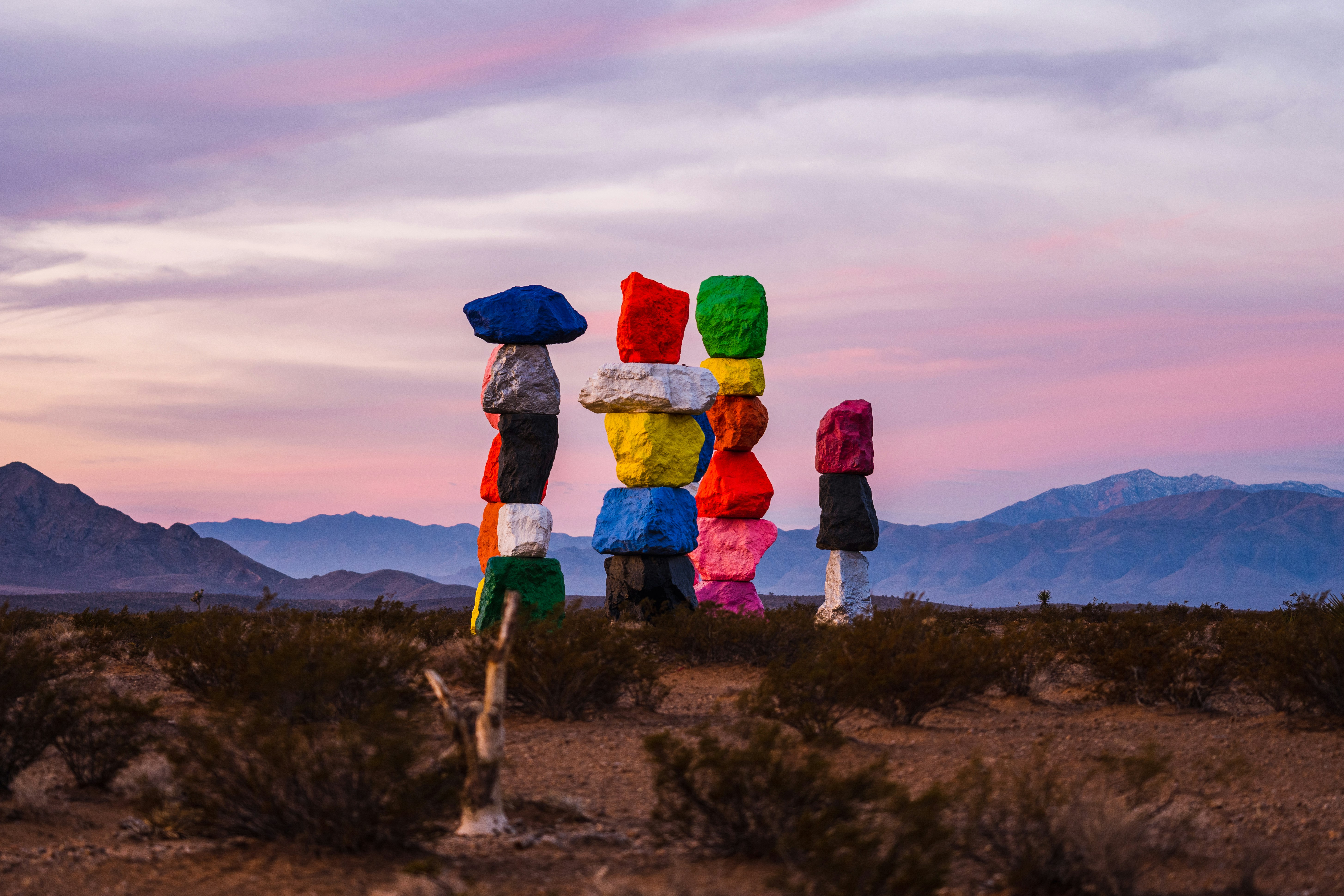 A group of people standing in the middle of a desert