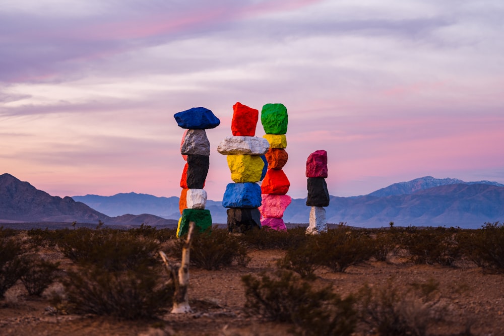 a group of people standing in the middle of a desert