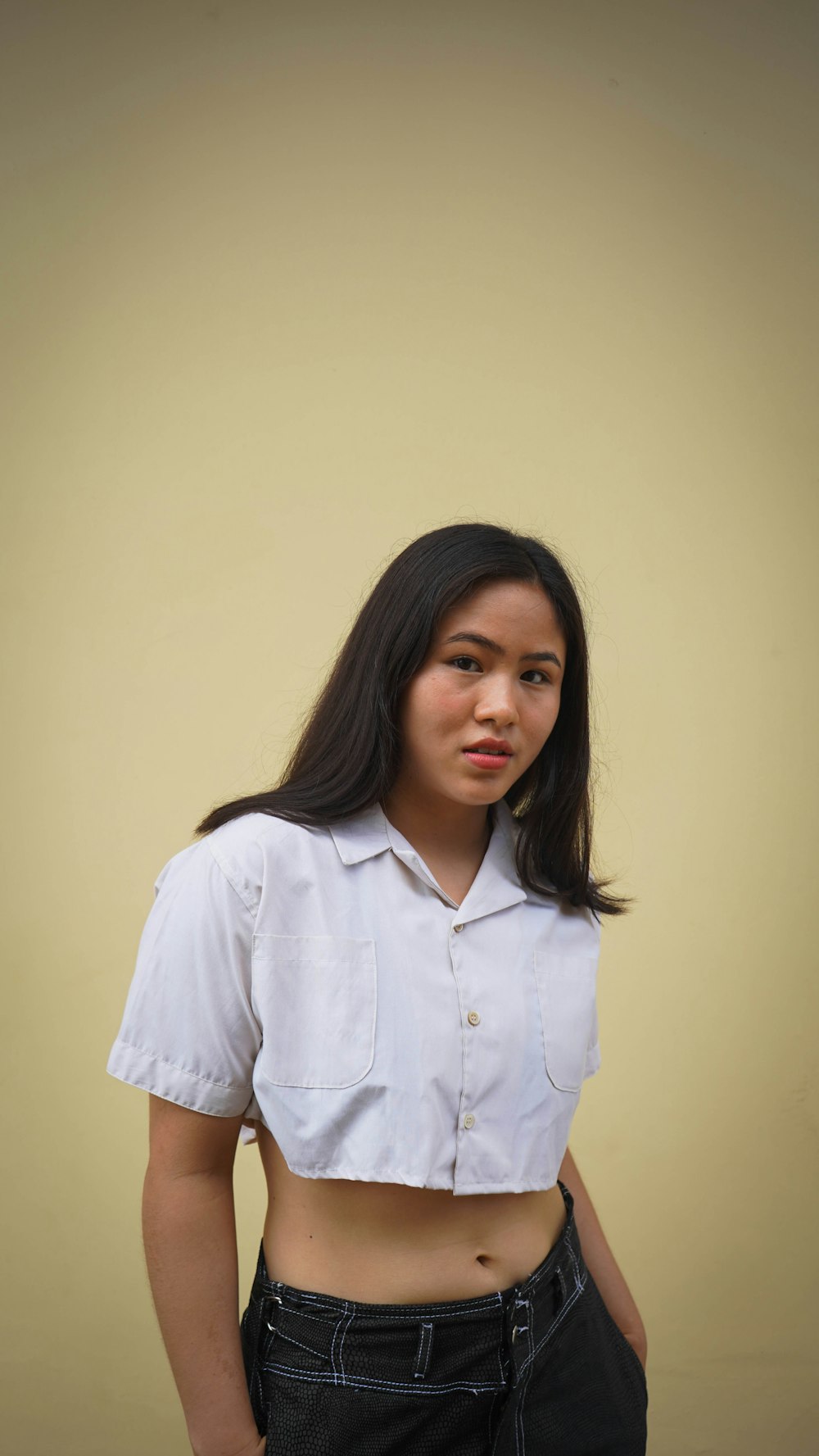 a woman in a white shirt posing for a picture