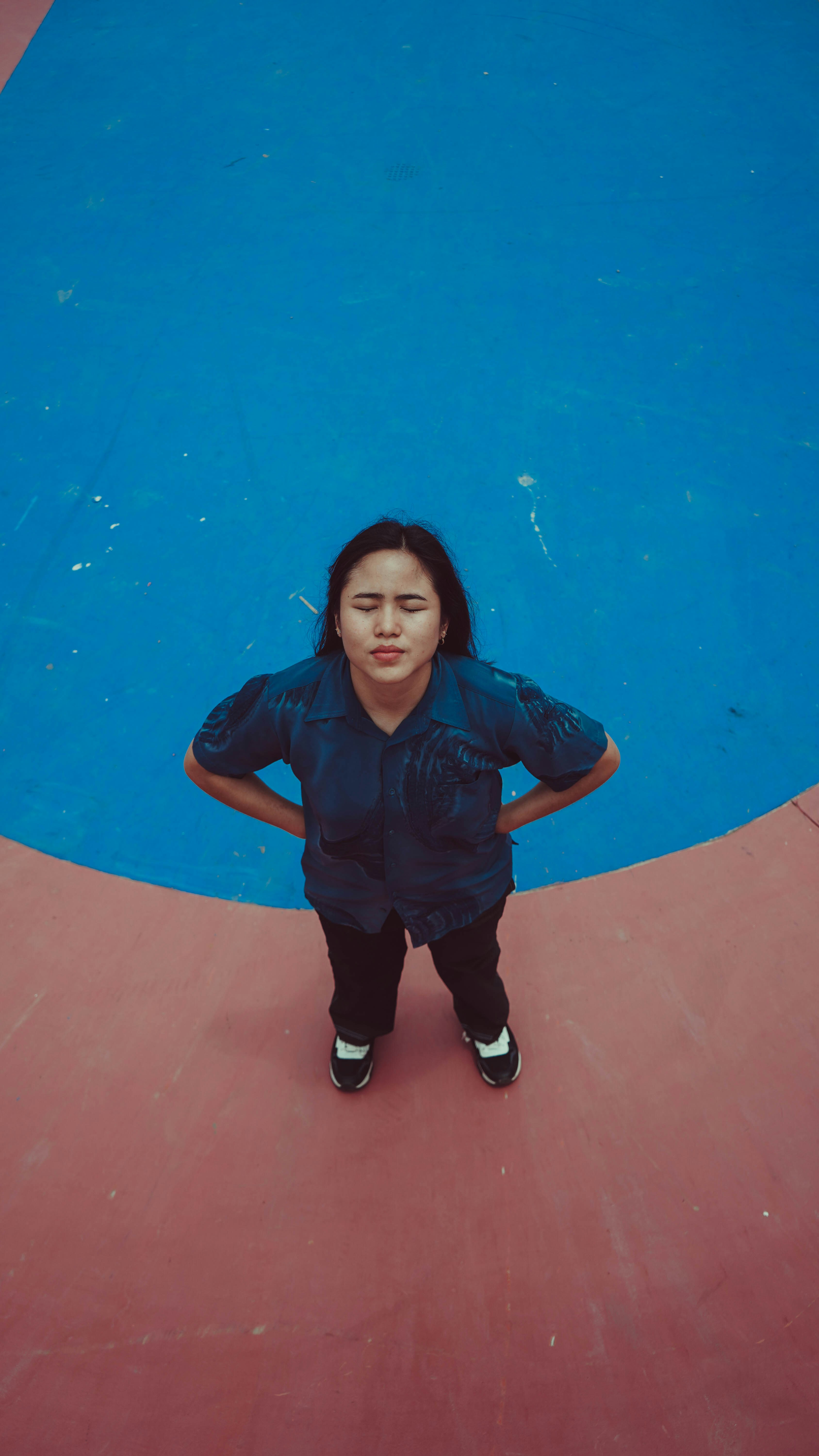 A little girl standing in front of a blue and pink wall photo – Free ...