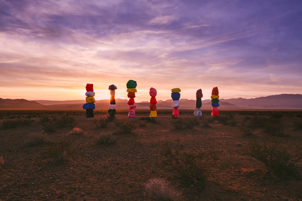 a number of colorful objects in the middle of a desert