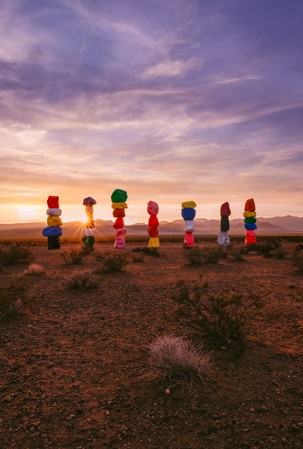 a group of balloons sitting in the middle of a desert
