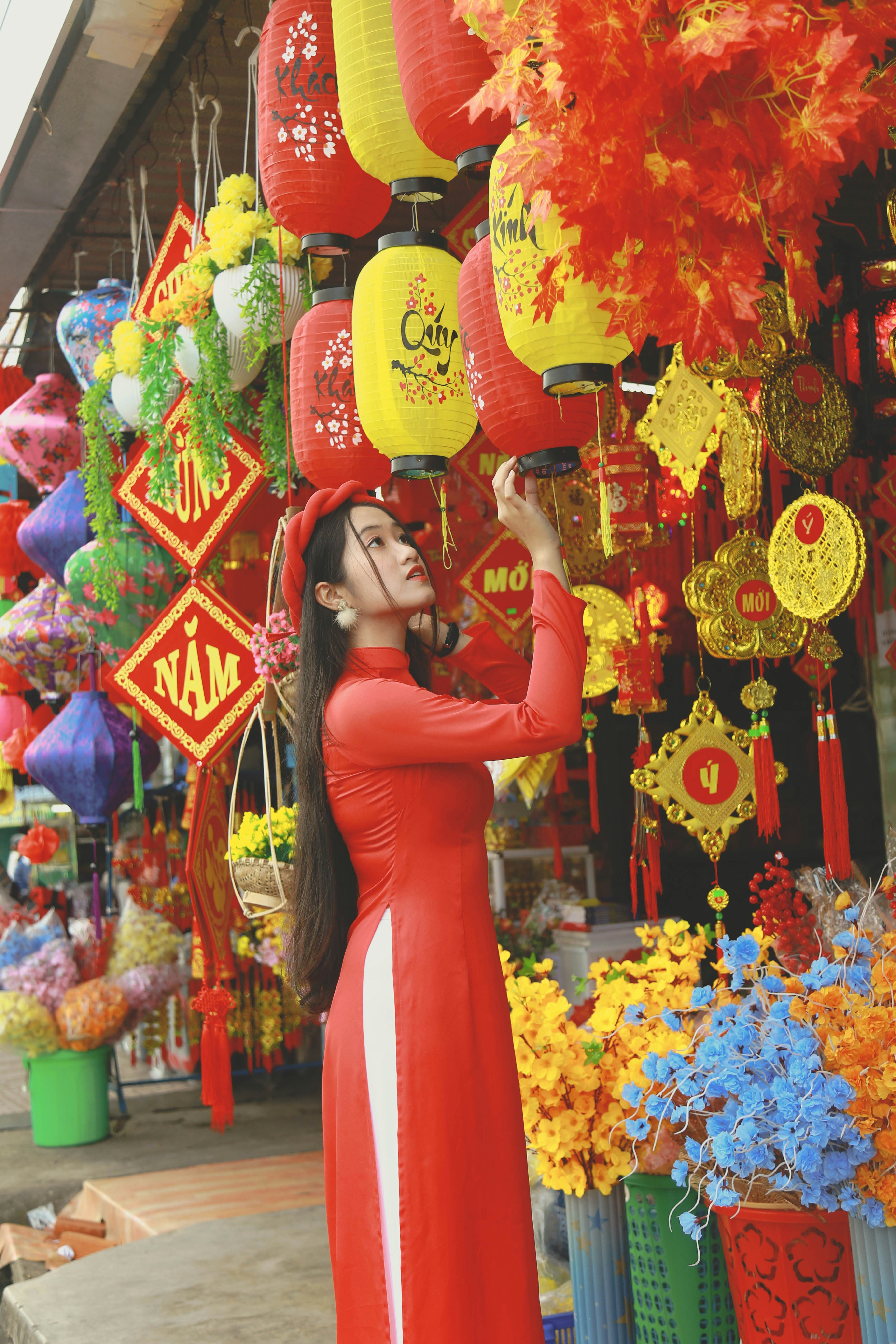 A woman in a red dress is holding a lantern photo – Free Flower Image ...
