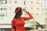 A smiling woman wearing a sleek, modern outfit from zarmtam prime, standing in a bright urban setting.