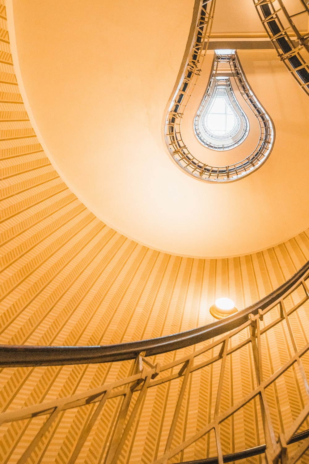 a spiral staircase in a building with a skylight