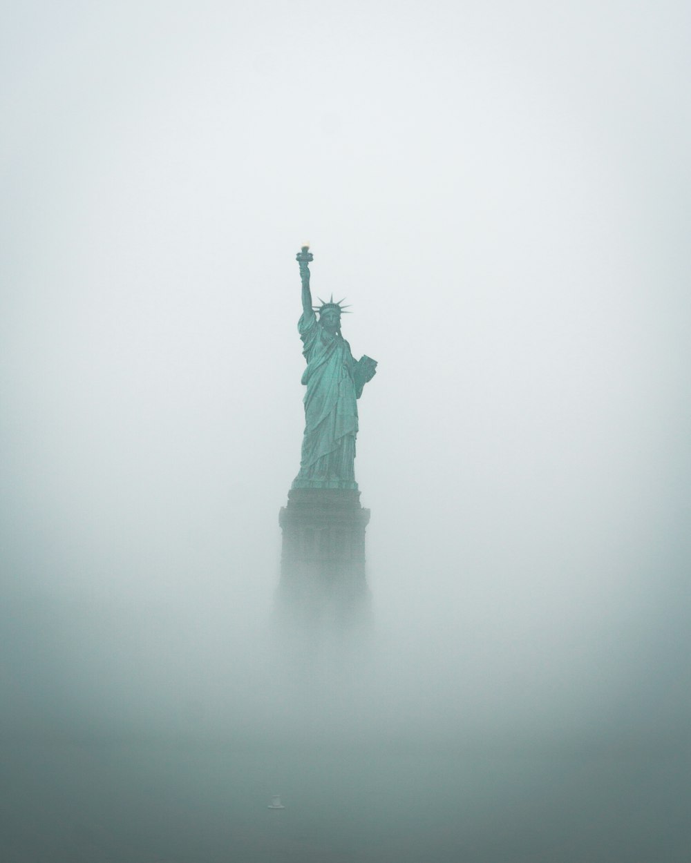 the statue of liberty is surrounded by fog