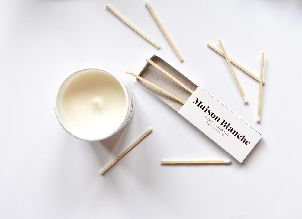 matchsticks and a cup of tea on a white surface