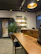 Photo of a modern wooden office desk with blue accent lighting highlighting the grain.