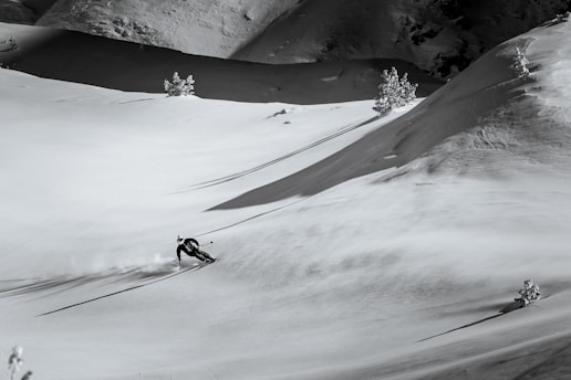 a man riding skis down a snow covered slope