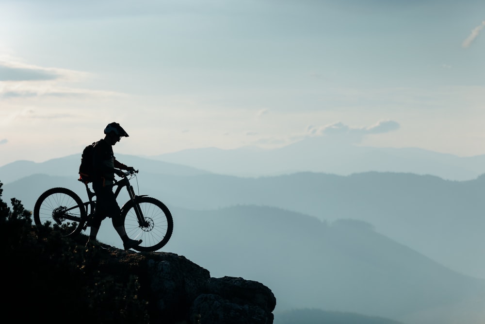 a person riding a bike on top of a mountain