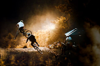 Dynamic shot of athletes swimming, cycling, and running together under bright sunlight.