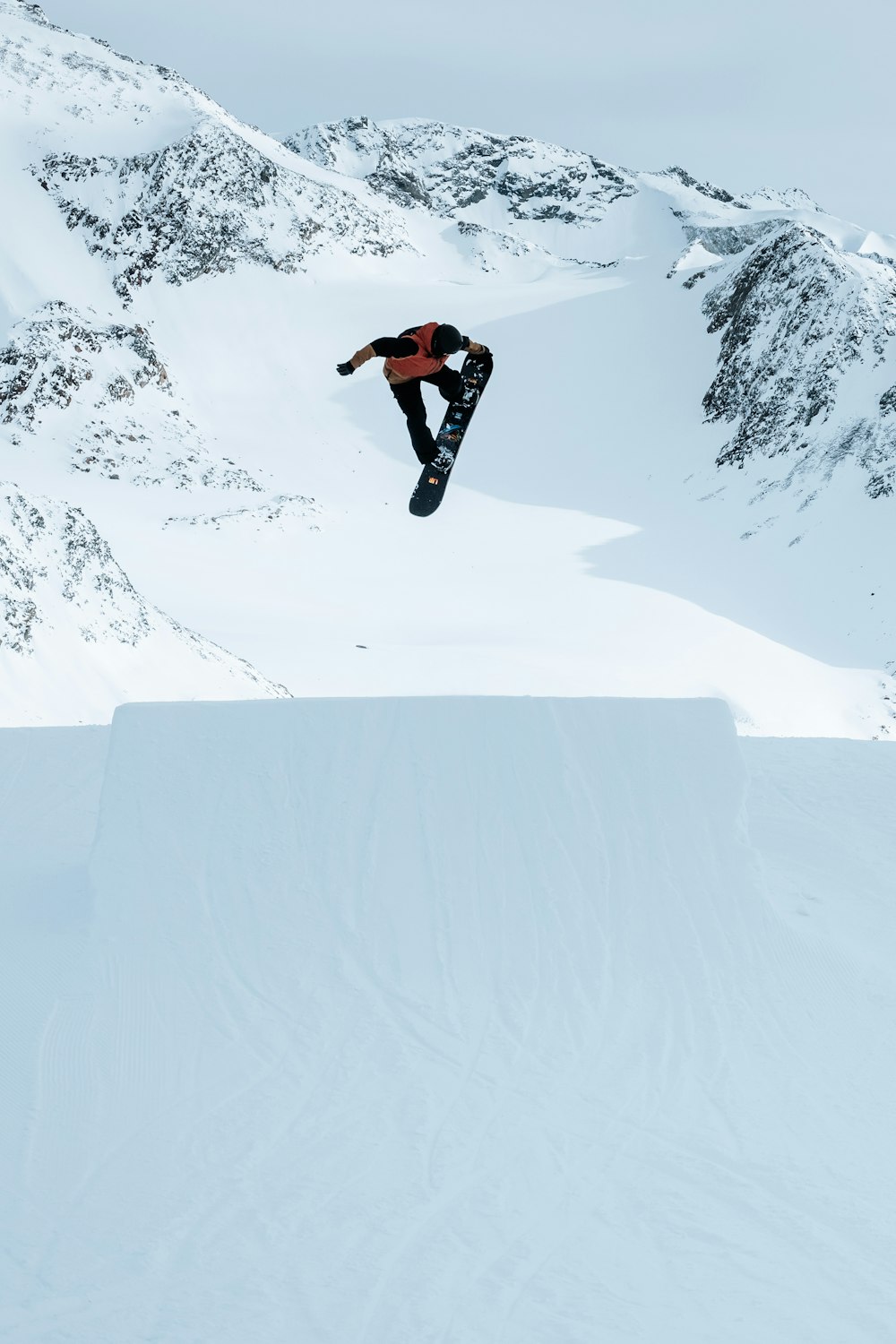 a man flying through the air while riding a snowboard