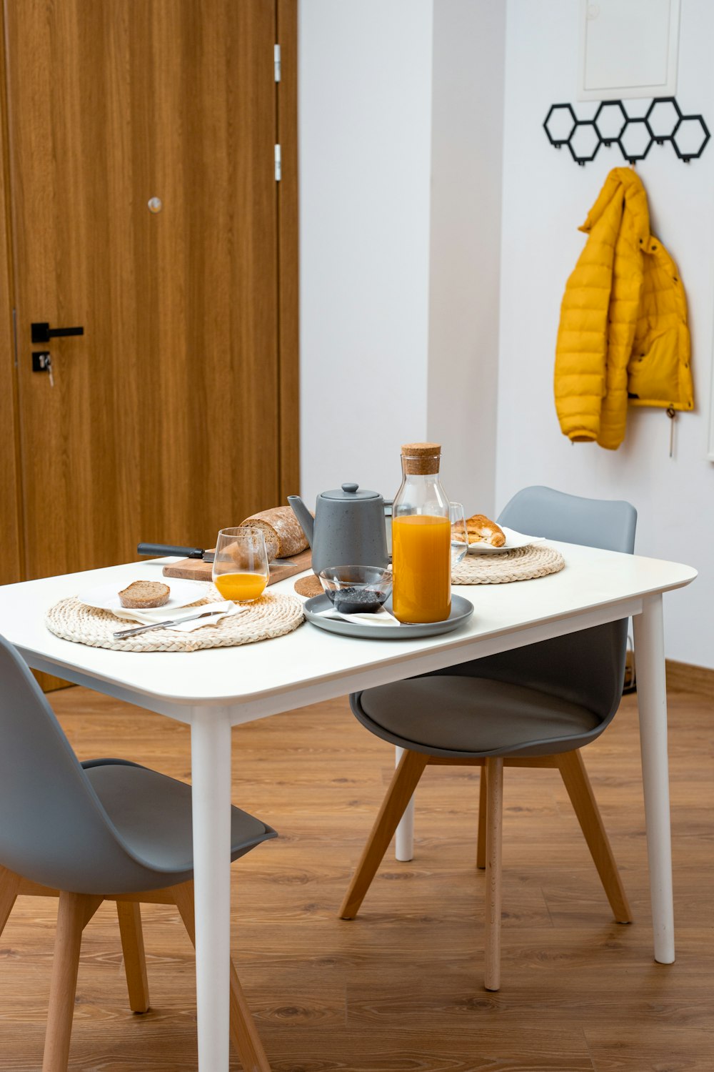 a white table with two chairs around it