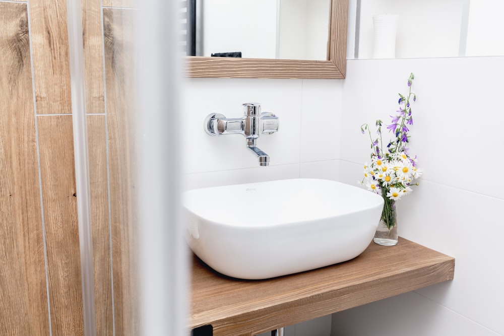 a bathroom sink sitting on top of a wooden counter