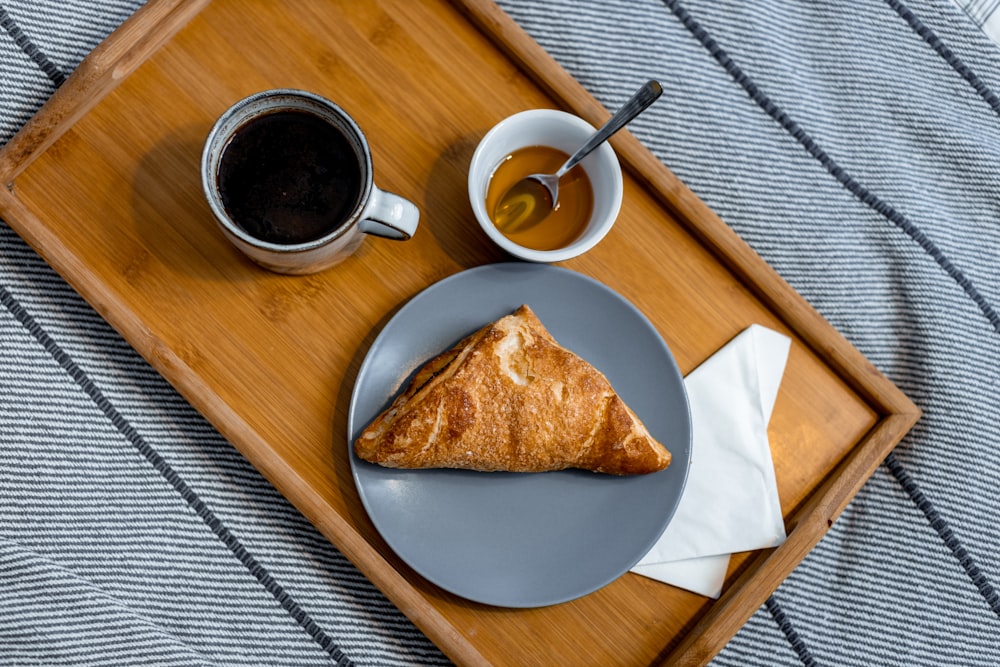 a plate of food and a cup of coffee on a tray