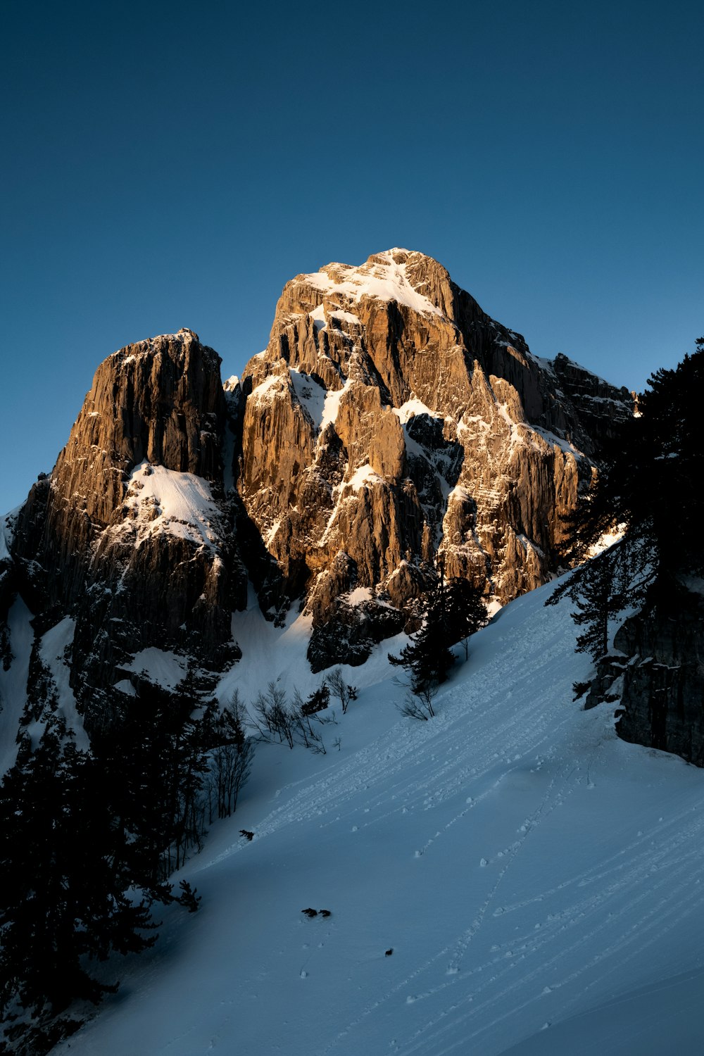 a snow covered mountain with a clear blue sky