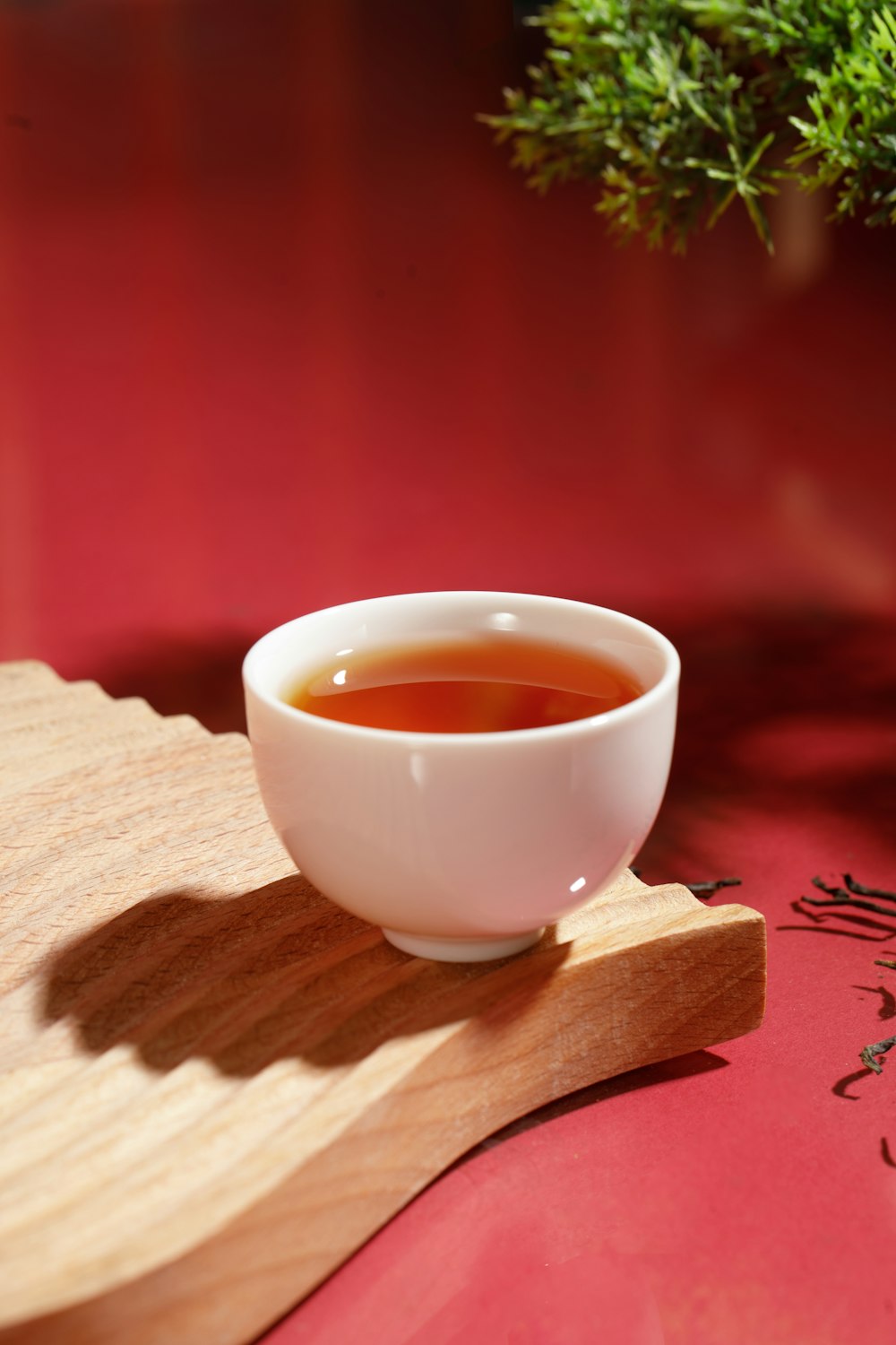a bowl of tea sitting on top of a wooden tray