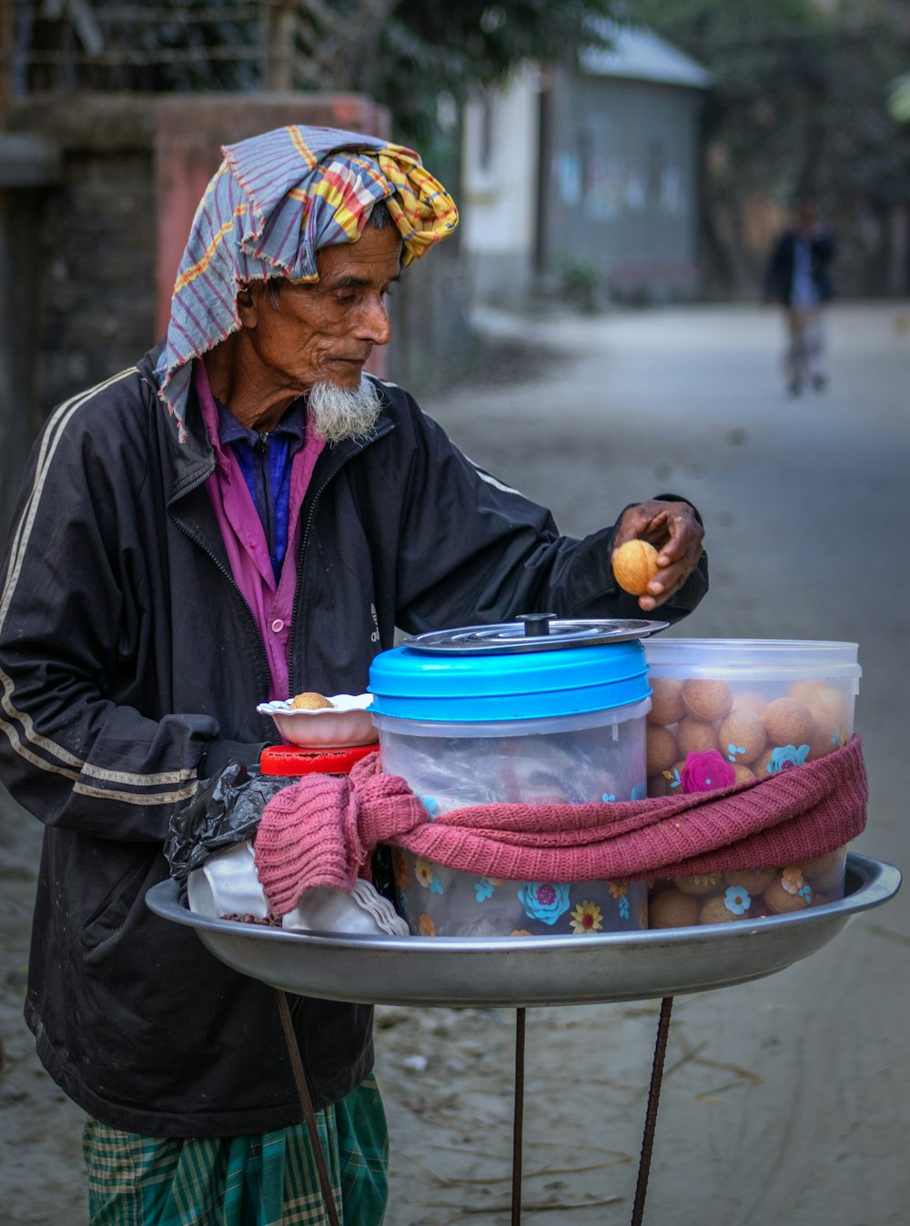 a man standing next to a tray of food