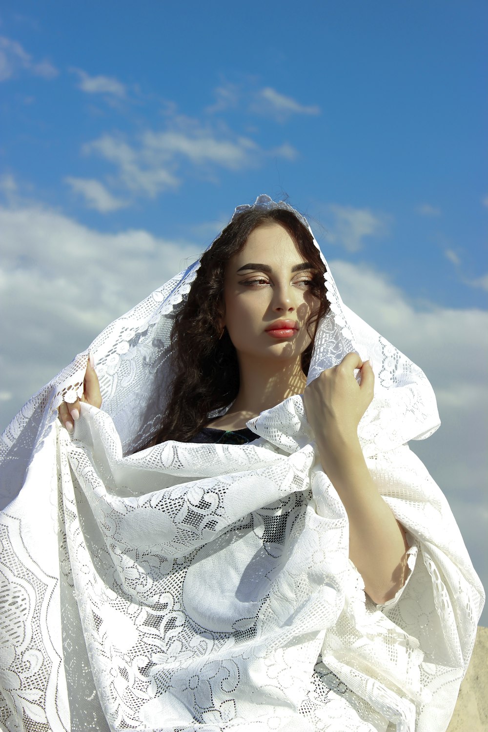 a woman with a white shawl on her head