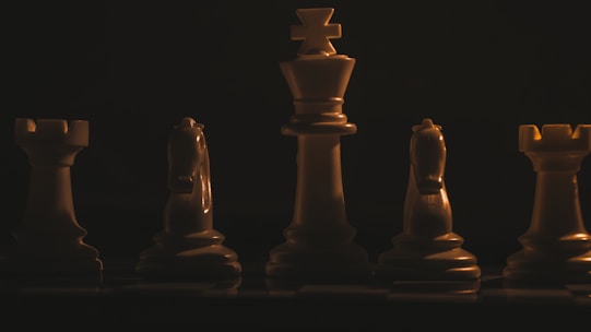 a group of chess pieces sitting on top of a chess board