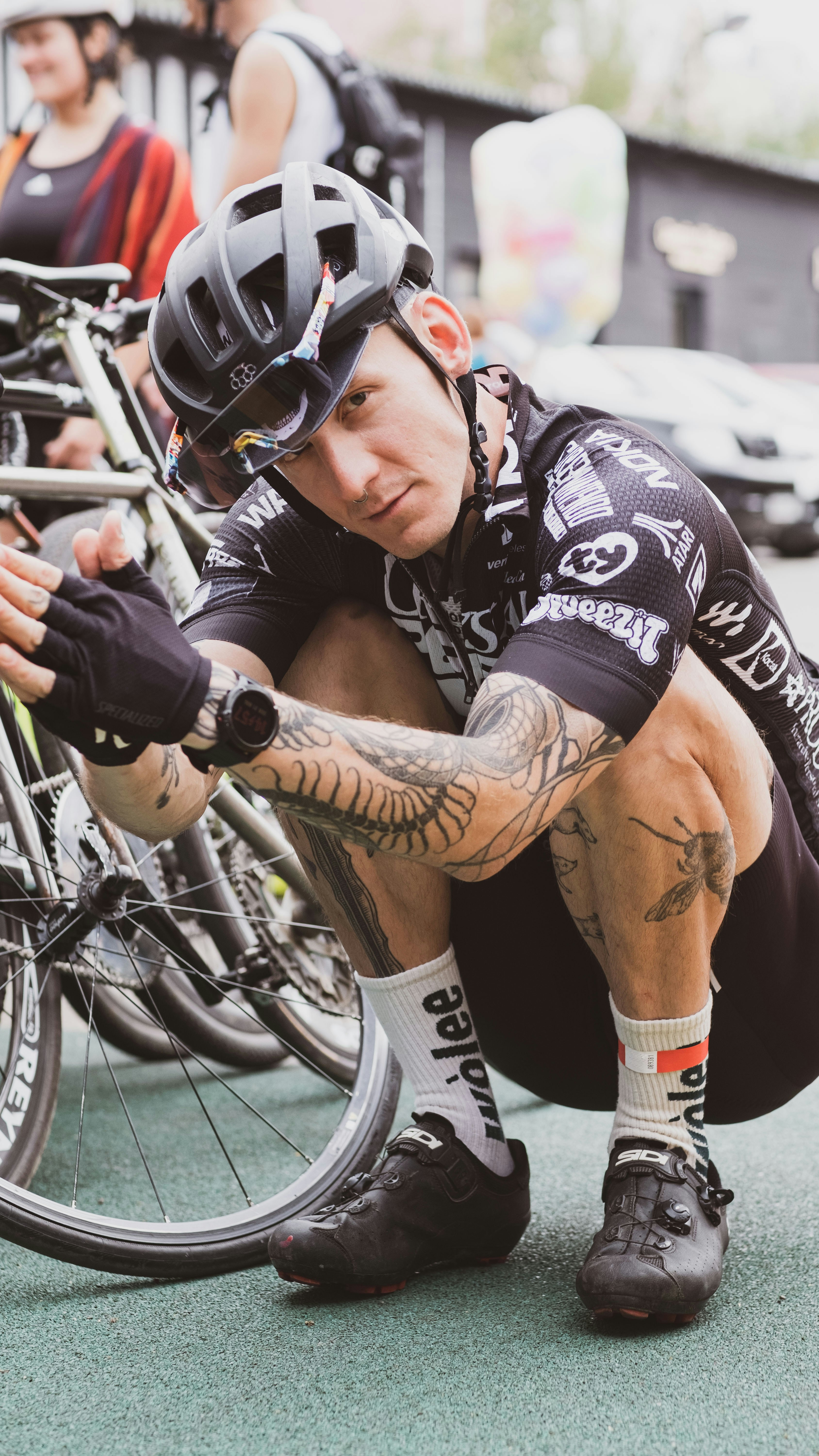 a man sitting on the ground next to a bike