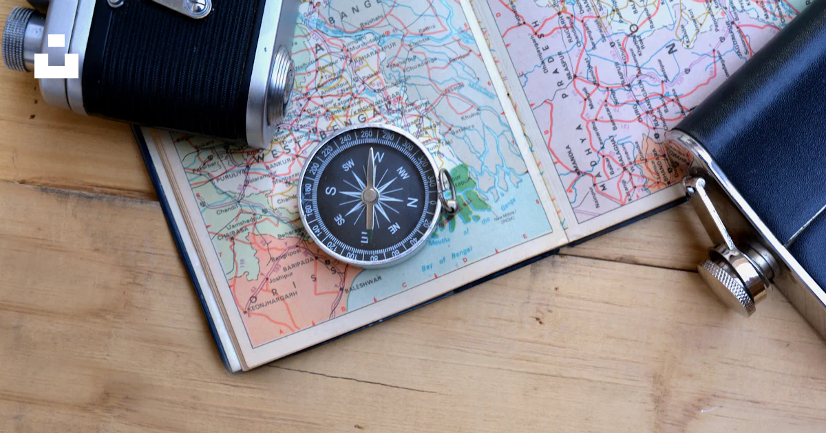 A map with a compass and a camera on it photo – Free Compass Image on ...