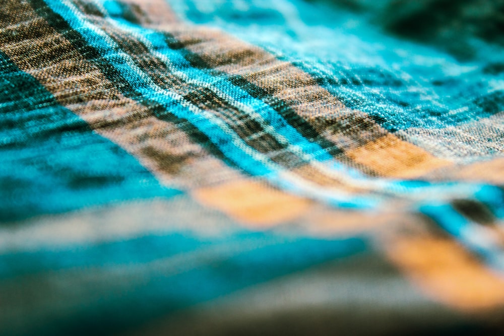 a close up of a blue and brown checkered blanket