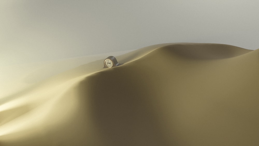 a desert scene with a small white object in the middle of the desert