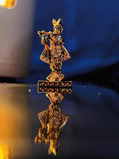 A glowing golden lyre resting on a marble pedestal with deep navy and black shadows in the background.