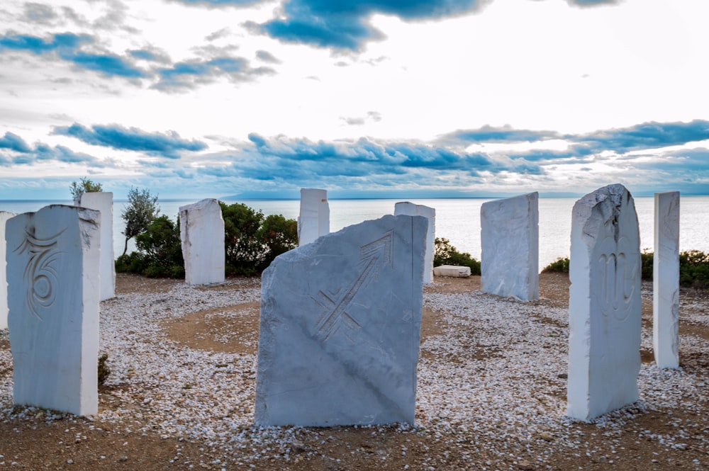 a group of white rocks sitting on top of a sandy beach