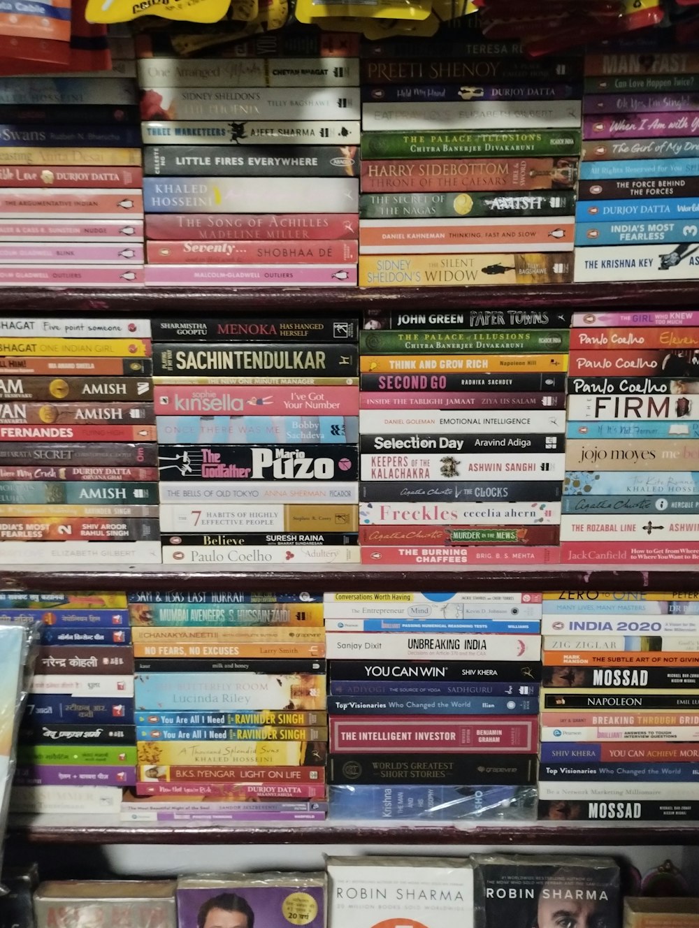 a pile of books sitting on top of a shelf