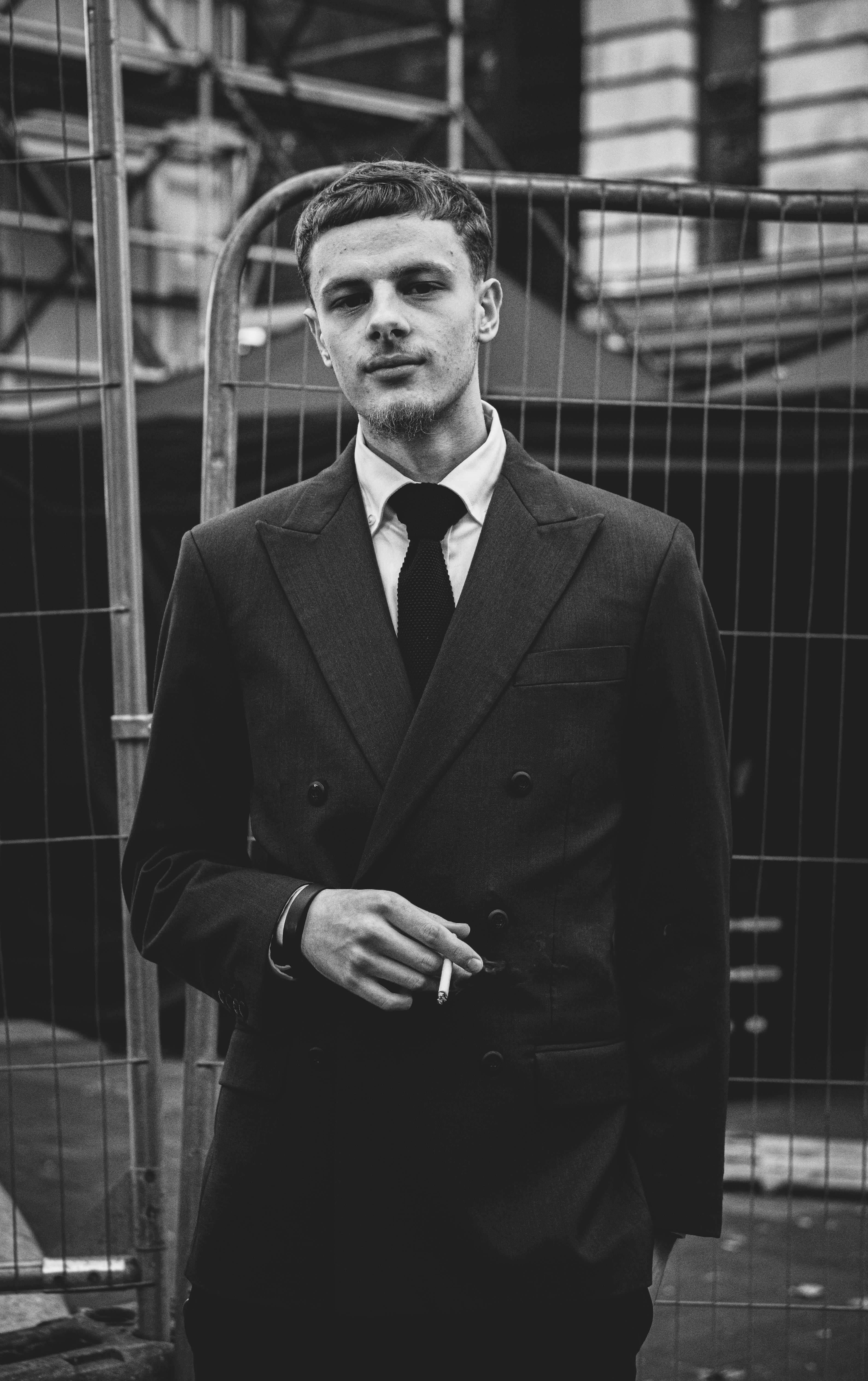 a black and white photo of a man in a suit