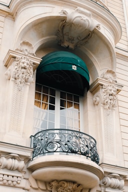 a balcony with a green awning over it