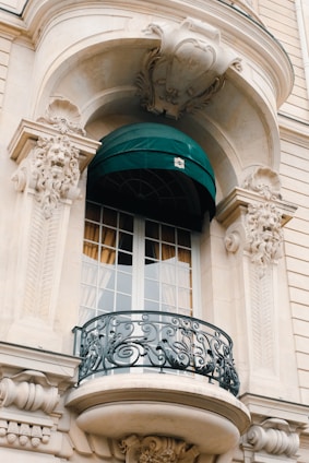 a balcony with a green awning over it