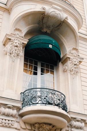 a balcony with a green awning over it