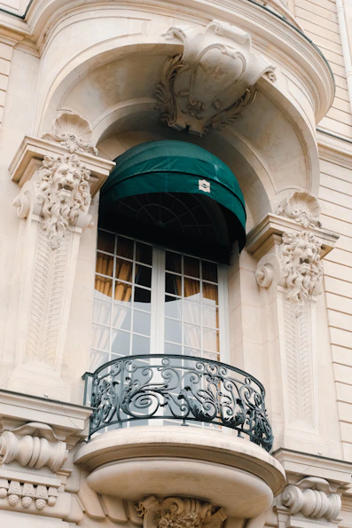 Parisian balcony with green awning, discreet charm of local architecture	