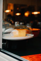 Natural yogurt cake with a subtle dusting of powdered sugar, captured with warm, inviting lighting.