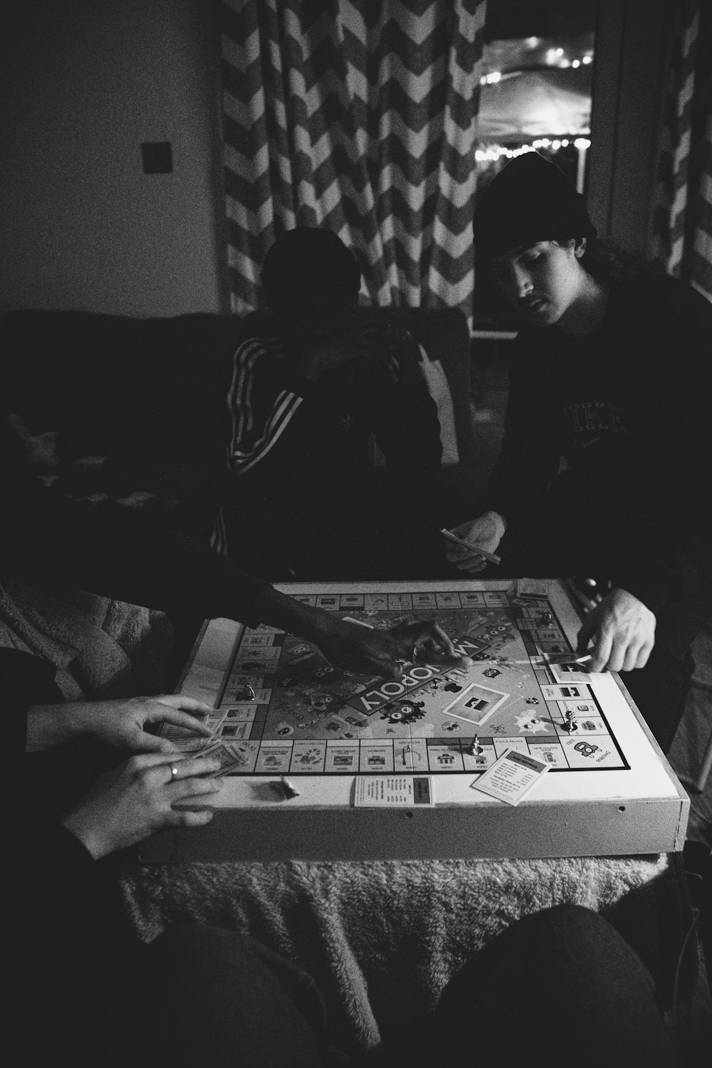 a couple of people playing a game of monopoly