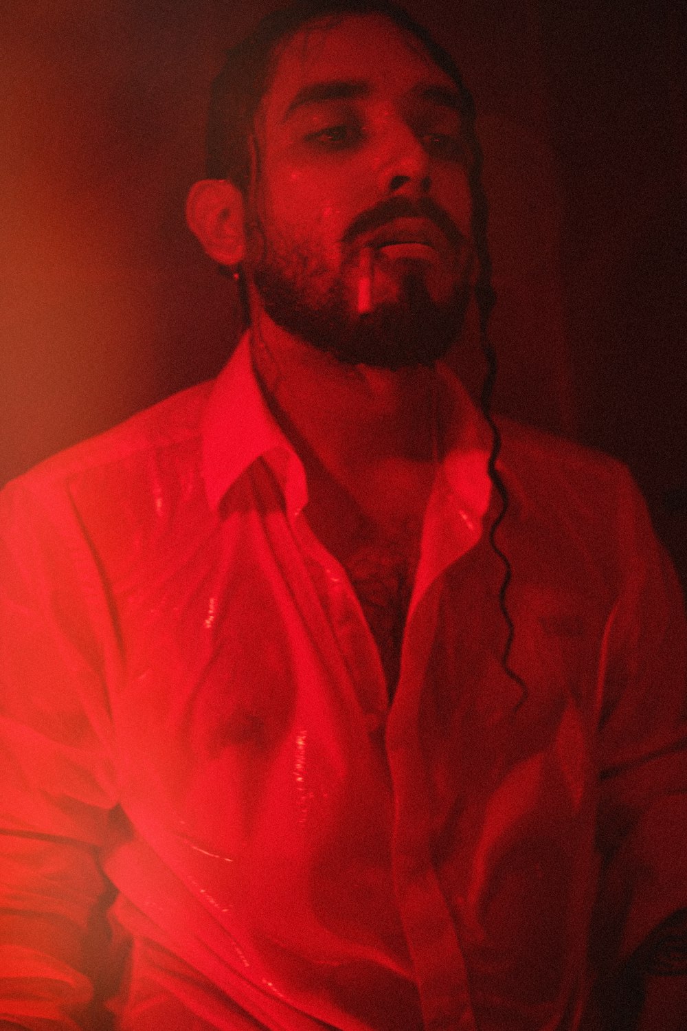 a man with a beard wearing a red shirt