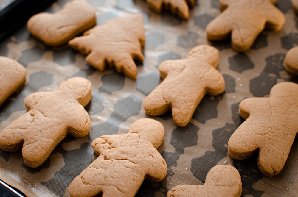 a tray of cookies that are shaped like people