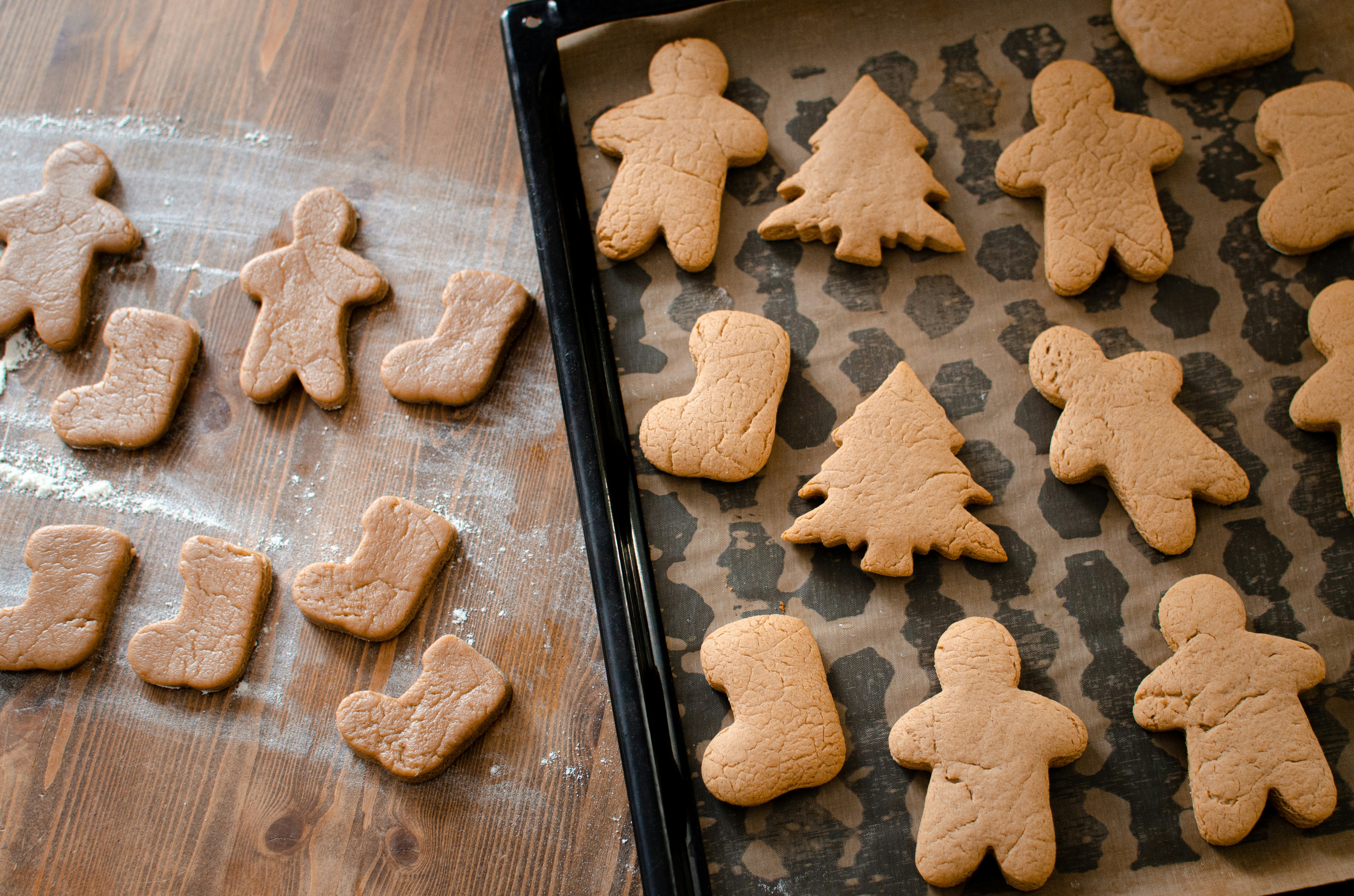 a cookie sheet with cut out ginger cookies on it