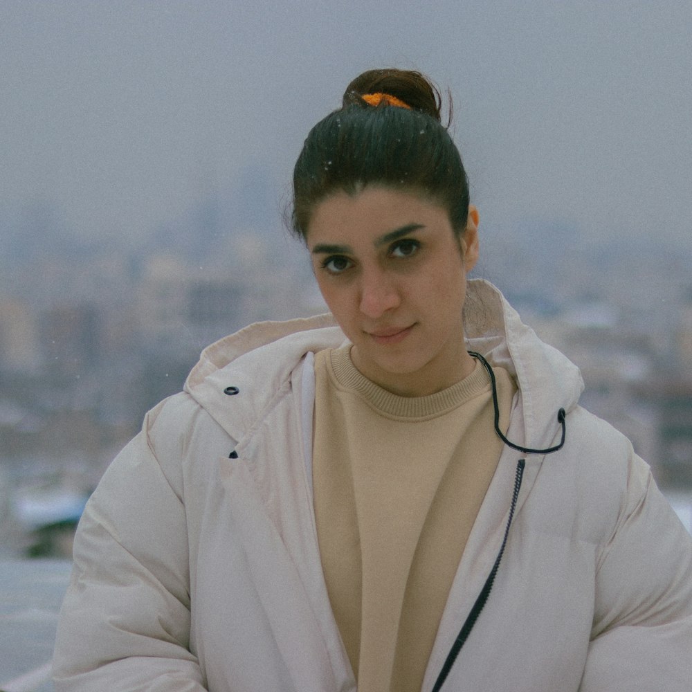 a woman standing in front of a cityscape