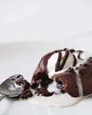 A rich chocolate lava cake with melting center, served with fresh berries and mint leaves.
