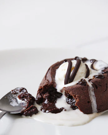 A rich chocolate lava cake with melting center, served with fresh berries and mint leaves.