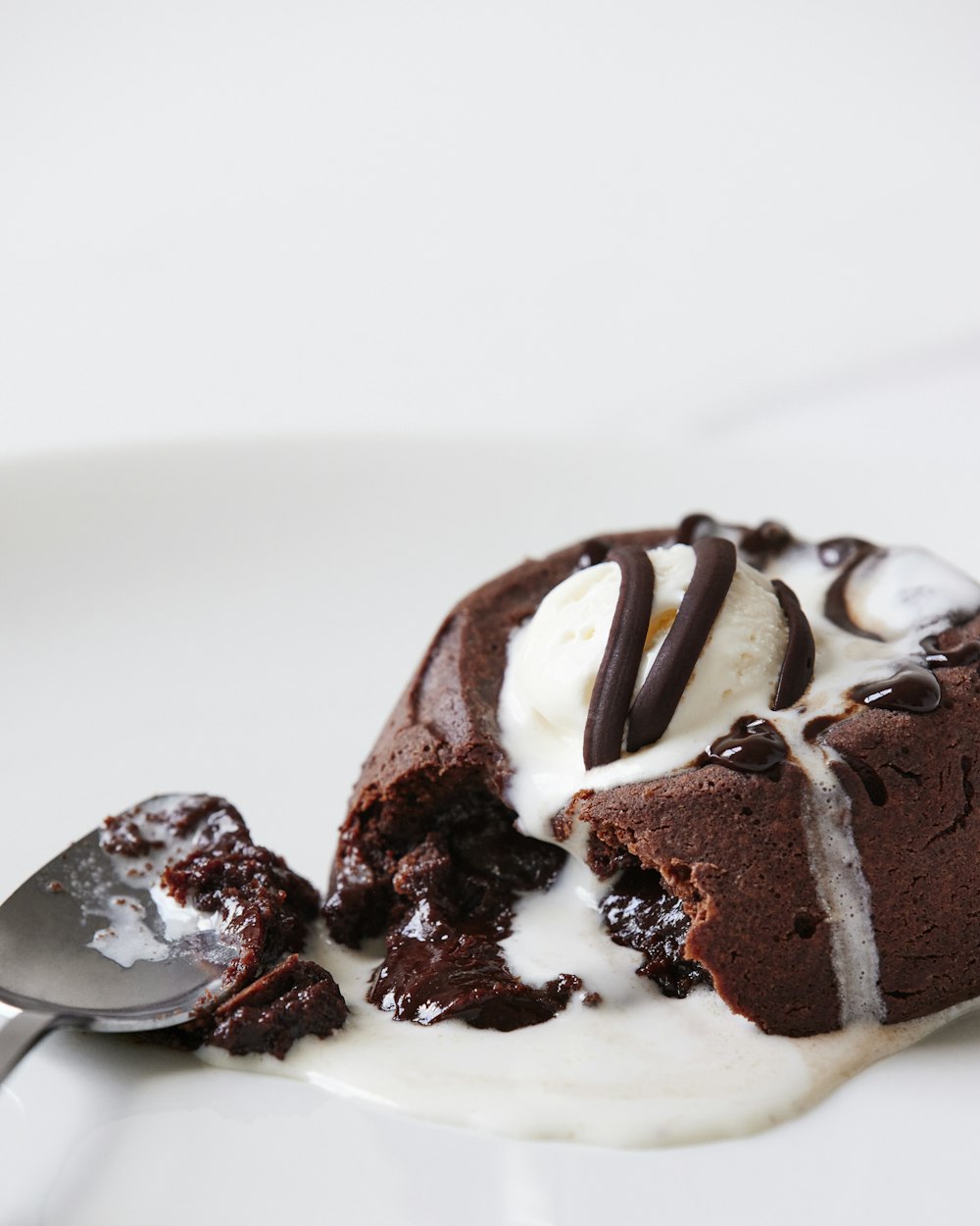 a white plate topped with a piece of cake and ice cream