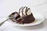 A decadent chocolate lava cake with molten center oozing onto a white plate.