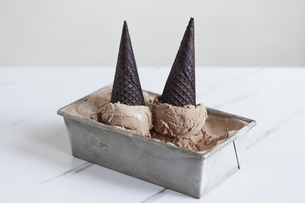two scoops of ice cream in a metal container