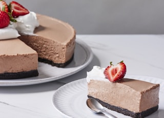 a slice of chocolate cheesecake with a strawberry on top