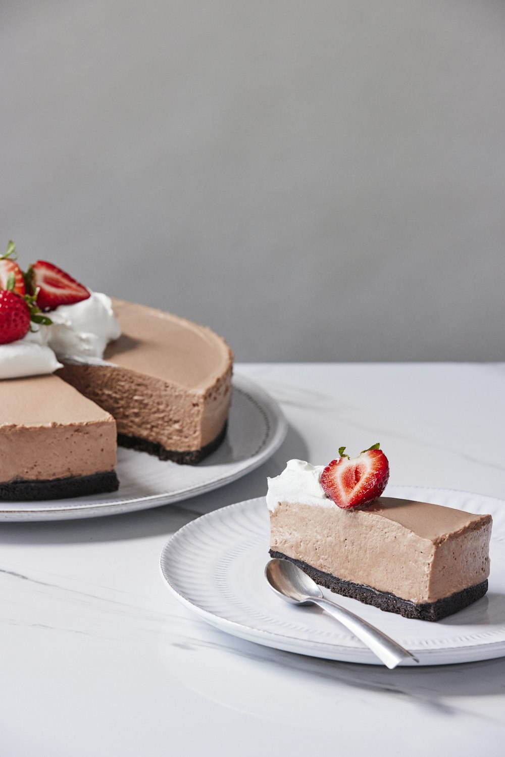 a slice of chocolate cheesecake with a strawberry on top