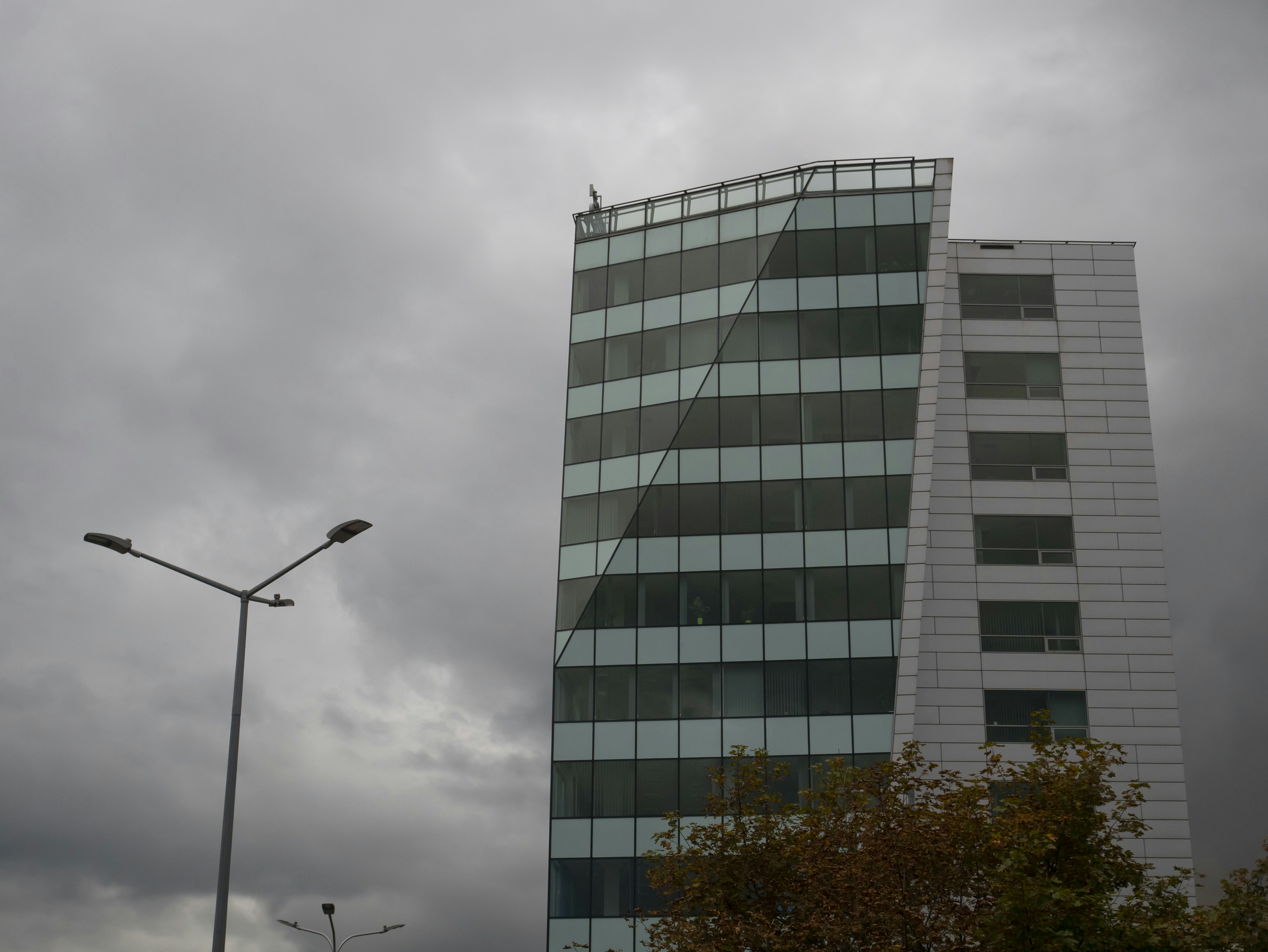a very tall building sitting next to a street light